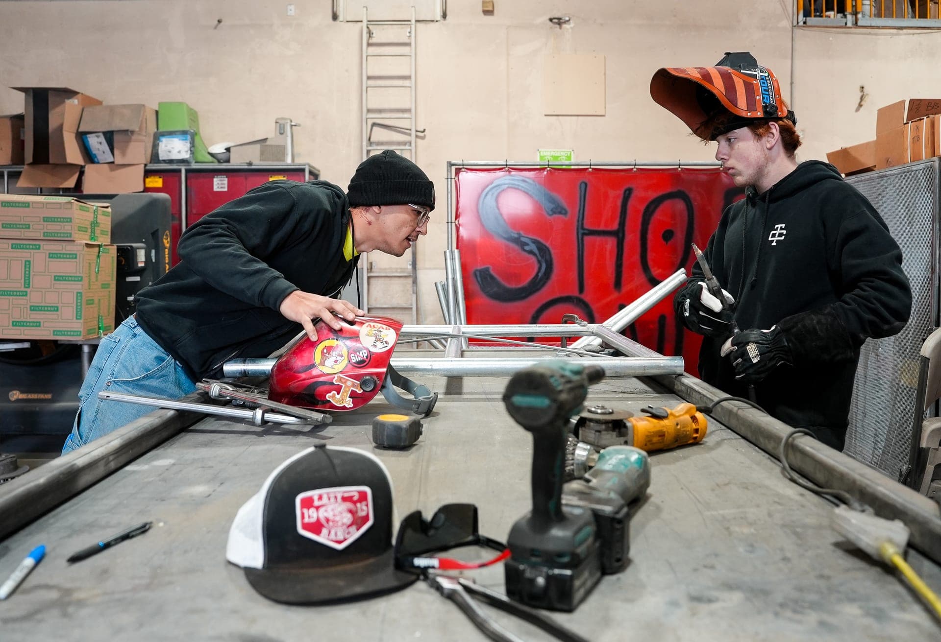 Two CCCA Works! students fabricating metal in a workshop